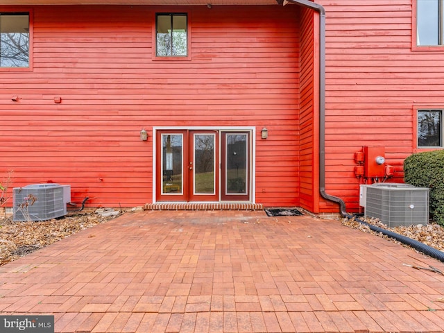 back of house featuring a patio area and central air condition unit