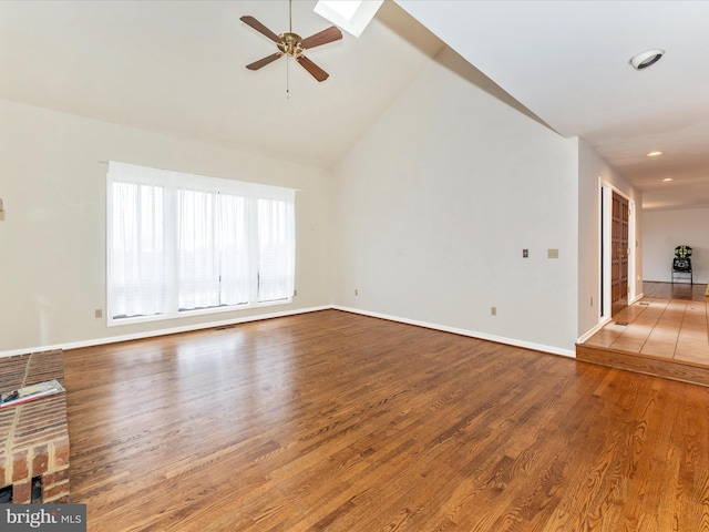 unfurnished living room with ceiling fan, hardwood / wood-style floors, and vaulted ceiling