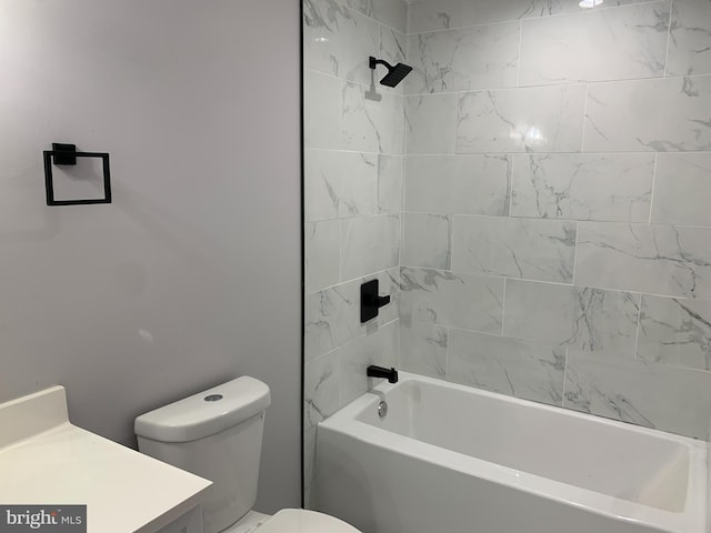 full bathroom with vanity, tiled shower / bath combo, and toilet