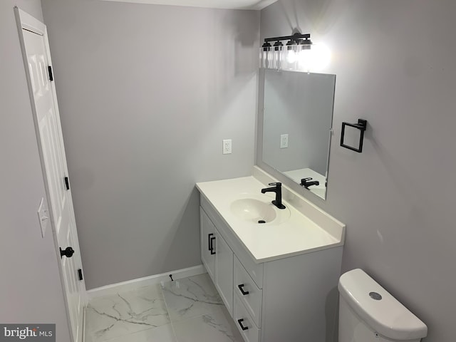 bathroom featuring vanity and toilet