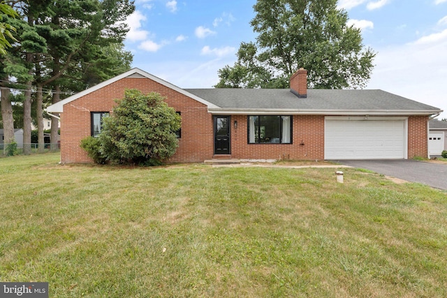 ranch-style home featuring a garage and a front lawn