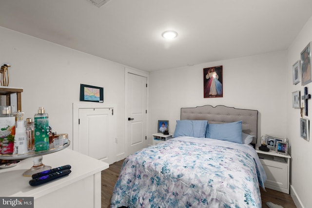 bedroom with dark wood-type flooring