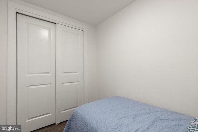 bedroom featuring a closet and dark wood-type flooring