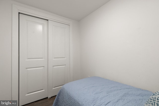 bedroom featuring dark hardwood / wood-style flooring and a closet