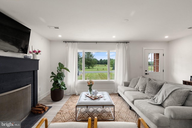 living room with a fireplace and light hardwood / wood-style floors