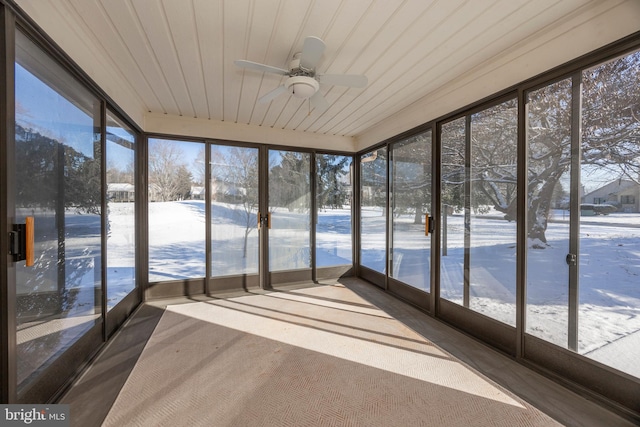 unfurnished sunroom with ceiling fan and wooden ceiling