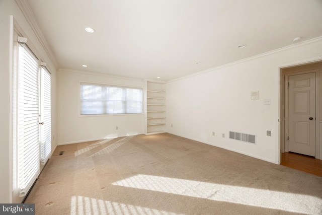 unfurnished bedroom with ornamental molding and light carpet