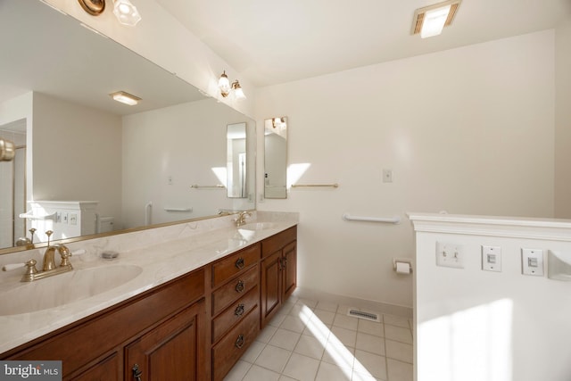 bathroom with vanity, tile patterned floors, and toilet