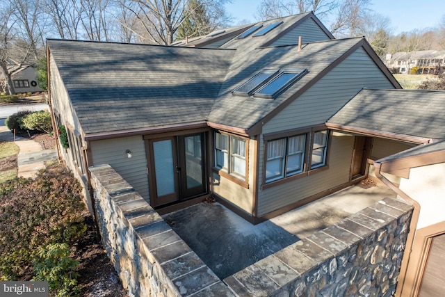 rear view of house featuring french doors