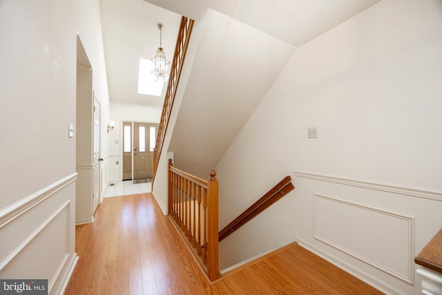 hallway featuring a chandelier and light wood-type flooring