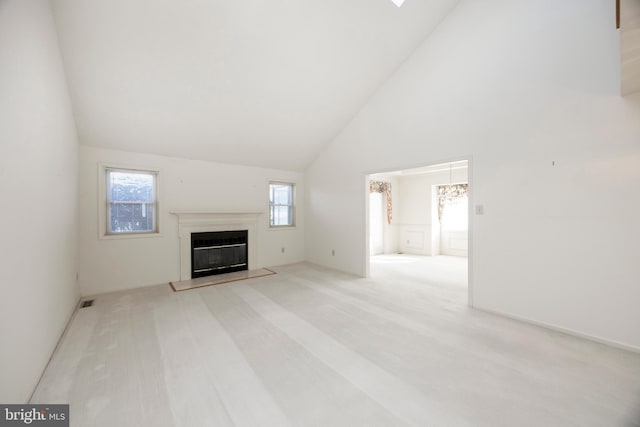 unfurnished living room with high vaulted ceiling