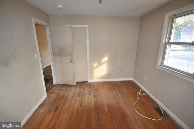 unfurnished room with hardwood / wood-style floors