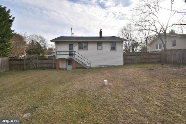 rear view of property with a lawn