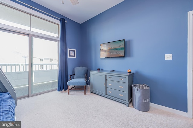 sitting room featuring ceiling fan and light carpet