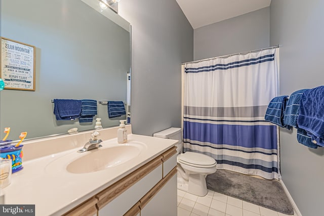 bathroom with toilet, vanity, tile patterned floors, and curtained shower