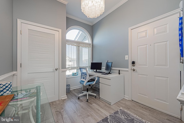 office area featuring light hardwood / wood-style flooring, an inviting chandelier, plenty of natural light, and crown molding