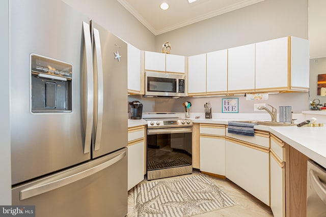 kitchen featuring white cabinets, appliances with stainless steel finishes, crown molding, and sink