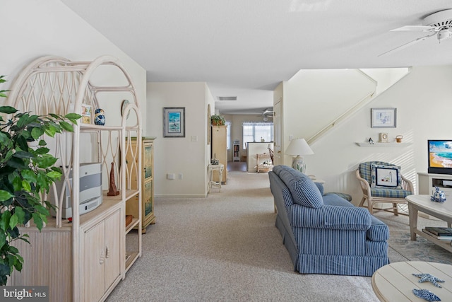 living room featuring ceiling fan and light carpet