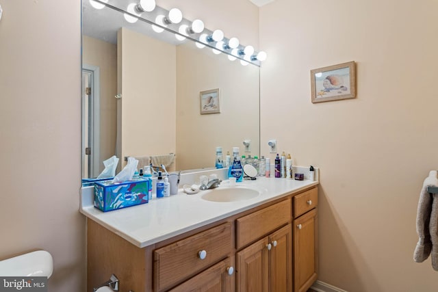 bathroom featuring vanity and toilet