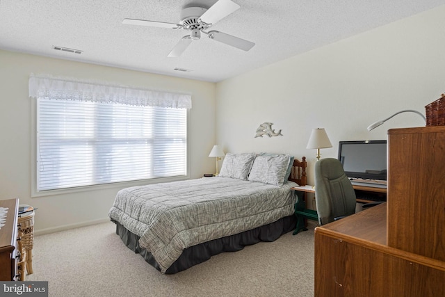 bedroom featuring carpet, a textured ceiling, and ceiling fan