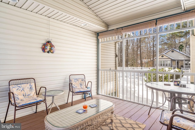 sunroom with a wealth of natural light and vaulted ceiling