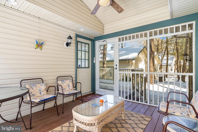 sunroom featuring ceiling fan and lofted ceiling