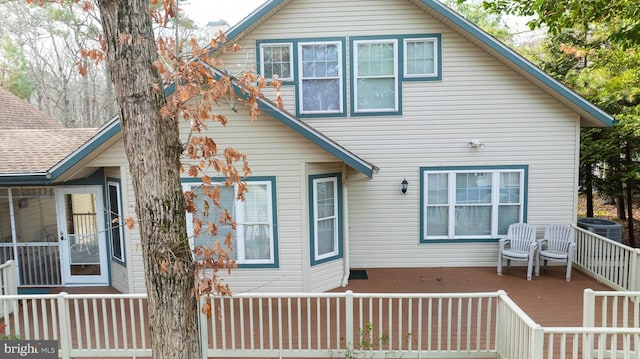 rear view of house featuring central AC unit