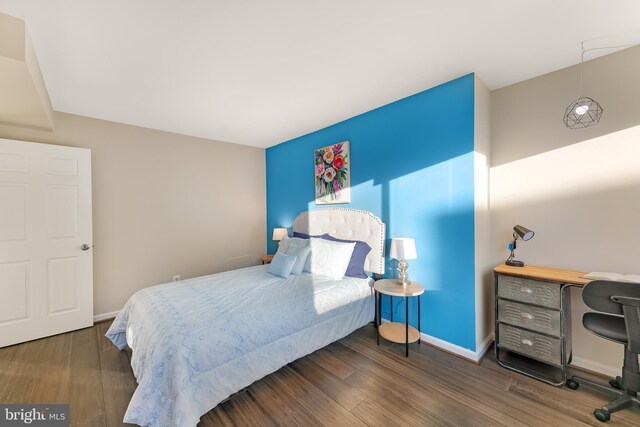 bedroom with dark wood-type flooring