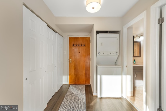 interior space featuring stacked washer and dryer and dark hardwood / wood-style floors