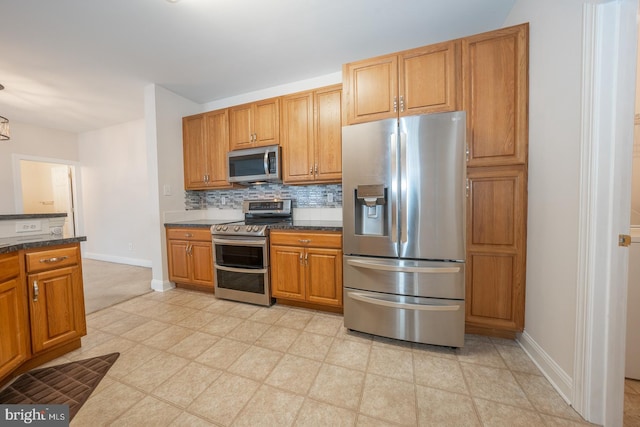 kitchen featuring stainless steel appliances and tasteful backsplash