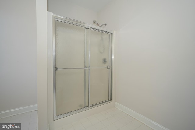 bathroom featuring a shower with shower door