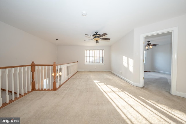 carpeted spare room with ceiling fan