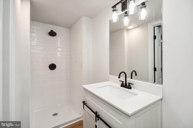 bathroom featuring vanity and tiled shower