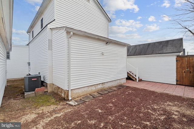 view of side of home featuring central AC