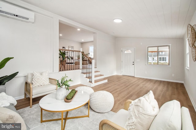 living room featuring light wood-type flooring, an AC wall unit, plenty of natural light, and wooden ceiling