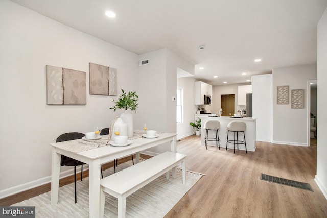 dining area with light hardwood / wood-style flooring