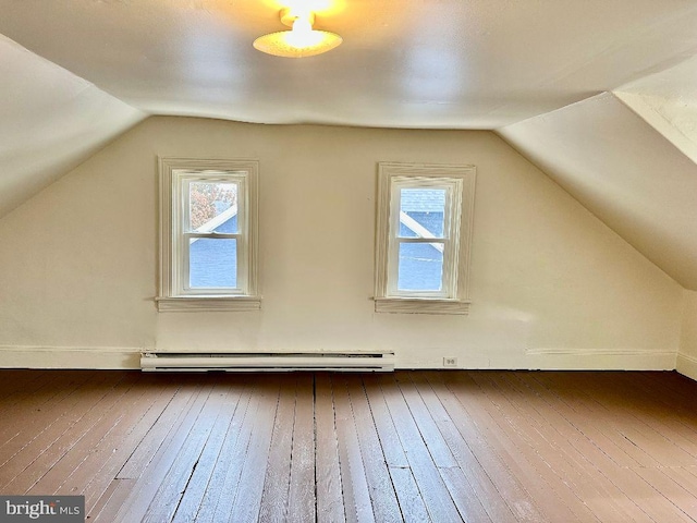 bonus room with a baseboard radiator, wood-type flooring, vaulted ceiling, and a wealth of natural light