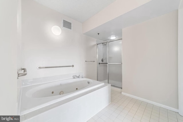 bathroom featuring tile patterned floors, separate shower and tub, and a textured ceiling