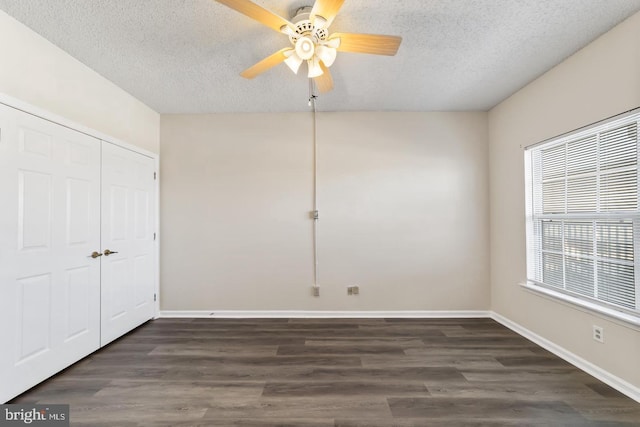 unfurnished bedroom with ceiling fan, dark hardwood / wood-style floors, and a textured ceiling