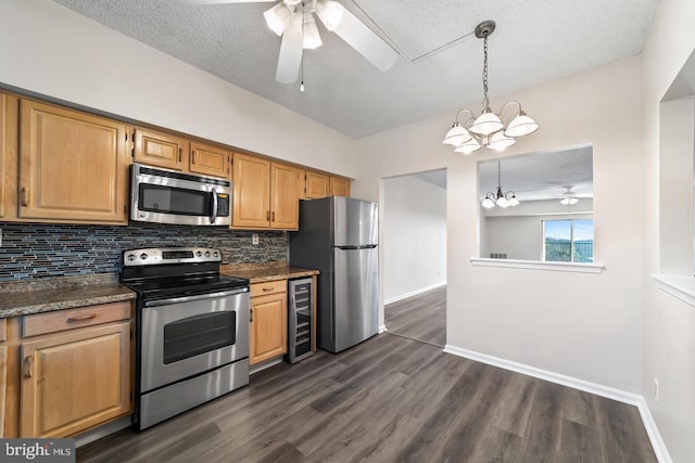 kitchen featuring decorative backsplash, ceiling fan with notable chandelier, stainless steel appliances, and wine cooler