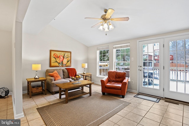 living room with light tile patterned floors, ceiling fan, and lofted ceiling