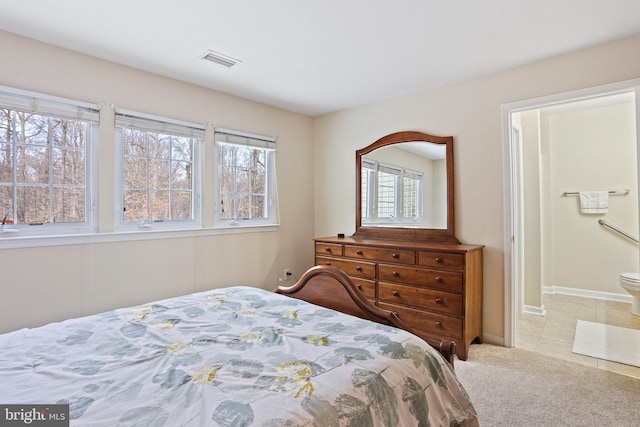 carpeted bedroom with ensuite bath