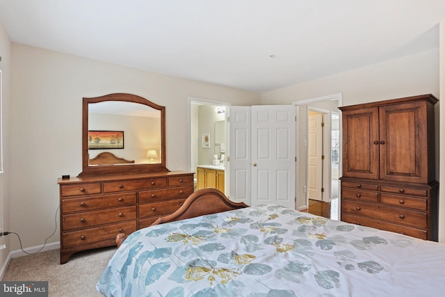 carpeted bedroom featuring connected bathroom