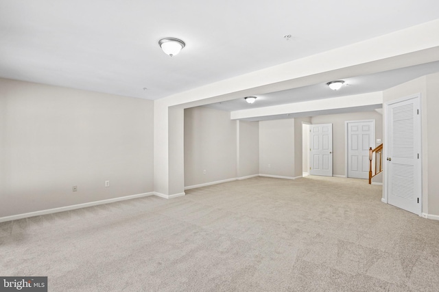 basement featuring light colored carpet