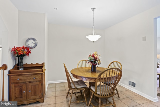 dining space featuring light tile patterned floors