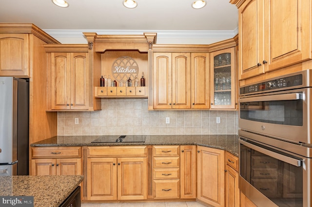 kitchen with stainless steel appliances, tasteful backsplash, and dark stone counters