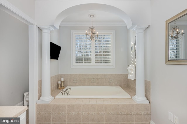 bathroom featuring a notable chandelier, crown molding, and a relaxing tiled tub