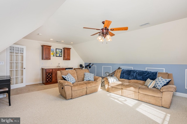 living room featuring sink, vaulted ceiling, light carpet, and ceiling fan