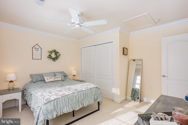 bedroom with ornamental molding, light colored carpet, ceiling fan, and a closet