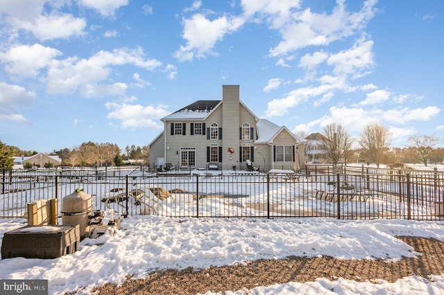 view of snow covered rear of property